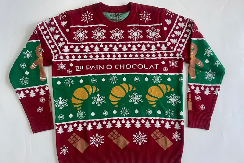 Cotton blend Christmas jumper material sample checked for softness and structure
