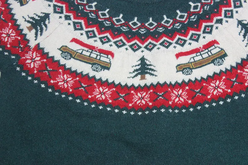 Buyer checking a wool blend Christmas jumper sample for texture cuffs and care label details