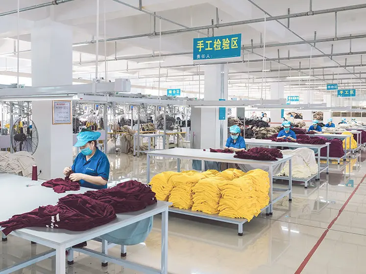 Quality control inspector checking sweaters