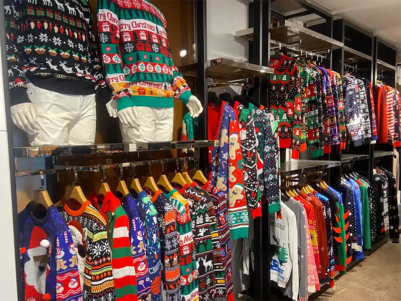 Custom Christmas sweater sample display in factory showroom